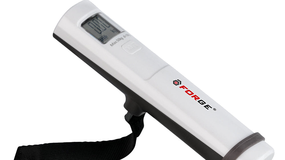 Handheld digital luggage scale measuring a bag's weight.